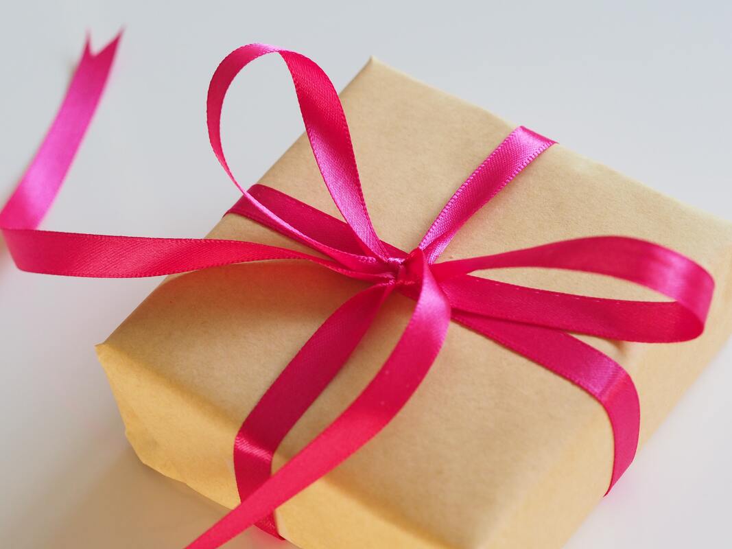 Gift box wrapped with a pink ribbon